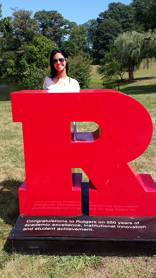Andreai Prata, a Ph.D. student from Brazil, poses with a large red letter “R” for Rutgers